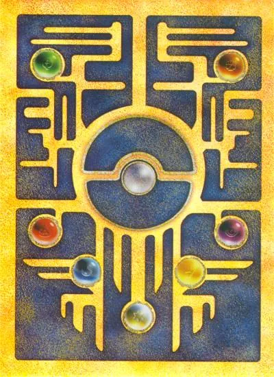 The reverse of Ancient Mew, a gold and blue design of ancient-looking script around a central Poke Ball, with coloured gems set into it, entirely unlike a standard Pokemon card back